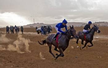 Off a desert highway in the south, Bedouins convene for weekly horse racing