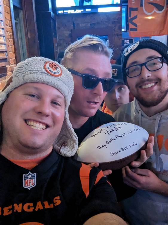 The Bengals postseason success has led to fun all over Cincinnati. Here, fans pose with a game ball delivered by the Bengals head coach following a win over the Buffalo Bills. (Photo courtesy of Matt Jacob)