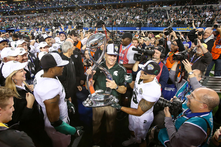 Photo Credit: Matthew Mitchell / MSU Athletic Communications. Mark Dantonio with 2015 Cotton Bowl trophy.