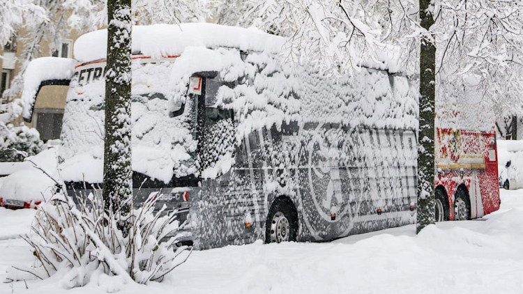 European football clash CANCELLED over safety fears after stadium and team bus are left buried in snow
