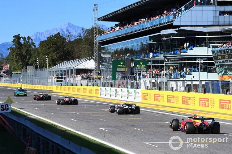 The Safety Car Max Verstappen, Red Bull Racing RB18, 1st position, over the line for victory ahead of Valtteri Bottas, Alfa Romeo C42, Yuki Tsunoda, AlphaTauri AT03, Charles Leclerc, Ferrari F1-75, 2nd position