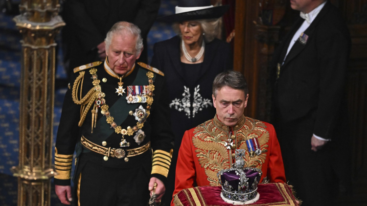 Britain's Prince Charles, left, and Camilla, Duchess of Cornwall, follow The Imperial State Crown in the House of Lords Chamber, during the State Opening of Parliament, in the Houses of Parliament, in London, Tuesday, May 10, 2022. Britainâ€™s Conservative government made sweeping promises to cut crime, improve health care and revive the pandemic-scarred economy as it laid the laws it plans in the next year in a tradition-steeped ceremony known as the Queenâ€™s Speech -- but without a key player, Queen Elizabeth II, absent for the first time in six decades. The 96-year-old monarch pulled out of the ceremonial State Opening of Parliament because of what Buckingham Palace calls â€œepisodic mobility issues.â€ Her son and heir, Prince Charles, stood in, rattling through a short speech laying out 38 bills the government plans to pass. (Ben Stansall/Pool Photo via AP)