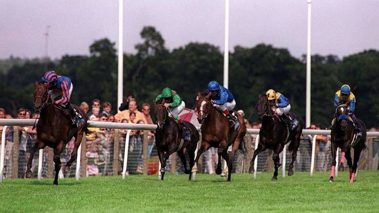 Mick Kinane glances at the big screen as Montjeu eases clear of his rivals in the 2000 King George