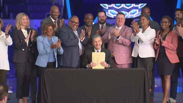 Gov. Cooper signs sports betting bill at Spectrum Center