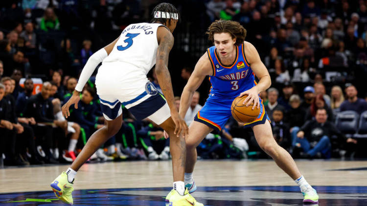 Josh Giddey of the Oklahoma City Thunder dribbles the ball while Jaden McDaniels of the Minnesota Timberwolves defends. Photo by Getty Images.