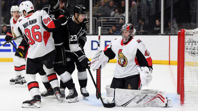 Craig Anderson of the Ottawa Senators makes a save as Dustin Brown of the Los Angeles Kings looks for the rebound. Photo by Getty Images.
