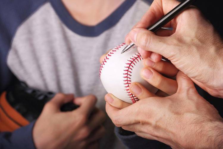 Boy getting an autograph on his baseballSome other related images: