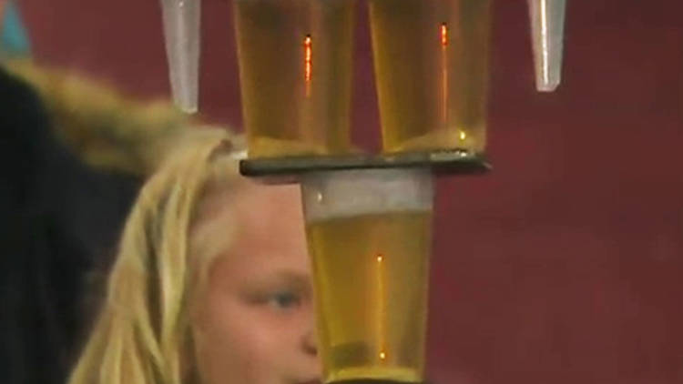 Watch incredible moment Bundesliga fan balances SEVEN pints of beer on his head during game