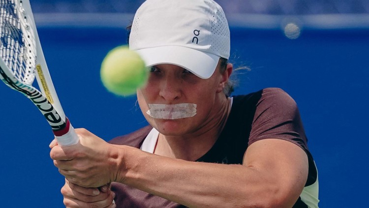 World No1 Iga Swiatek baffles tennis fans as she plays with TAPE over her mouth... but one reckons they know why