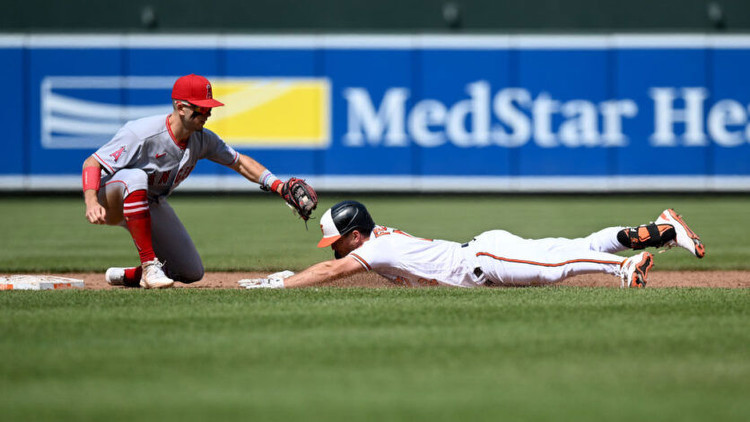 Adam Frazier of the Baltimore Orioles is tagged out trying to stretch a single into a double in the ninth inning by Zach Neto of the Los Angeles Angels. Photo by Getty Images.