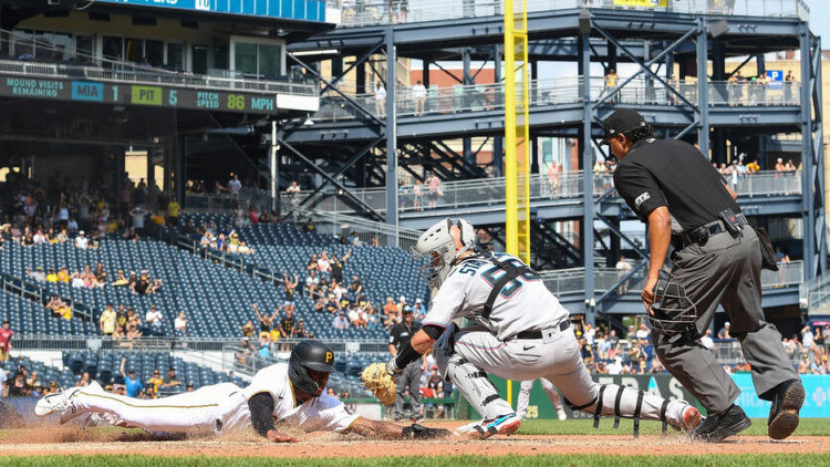 Greg Allen of the Pittsburgh Pirates slides in safely past Jacob Stallings of the Miami Marlins. Photo by Getty Images.