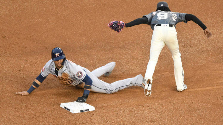 Yuli Gurriel of the Houston Astros steals second base on Dee Strange-Gordon of the Washington Nationals. Photo by Getty Images.